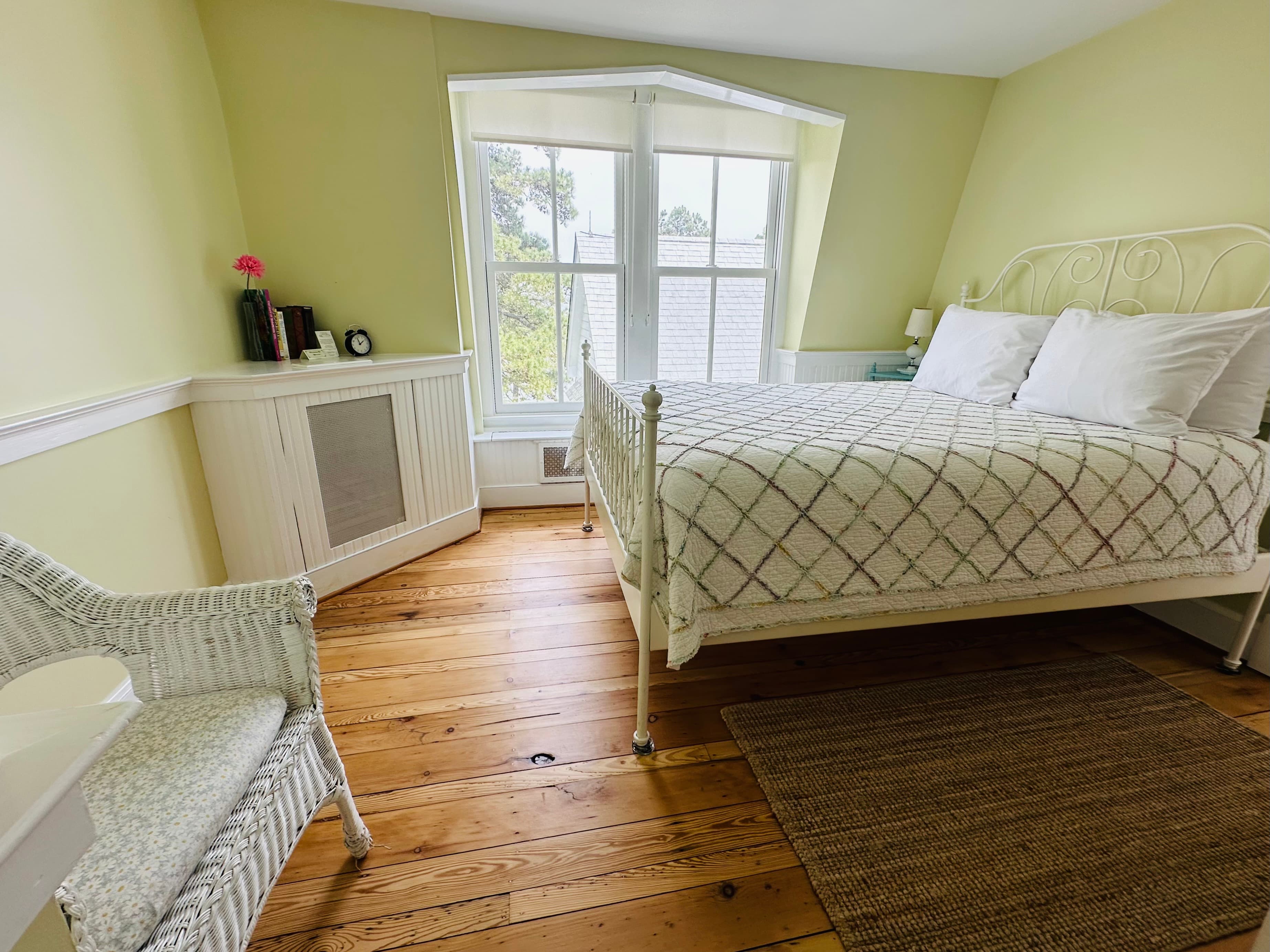 Queen bed by window with water view